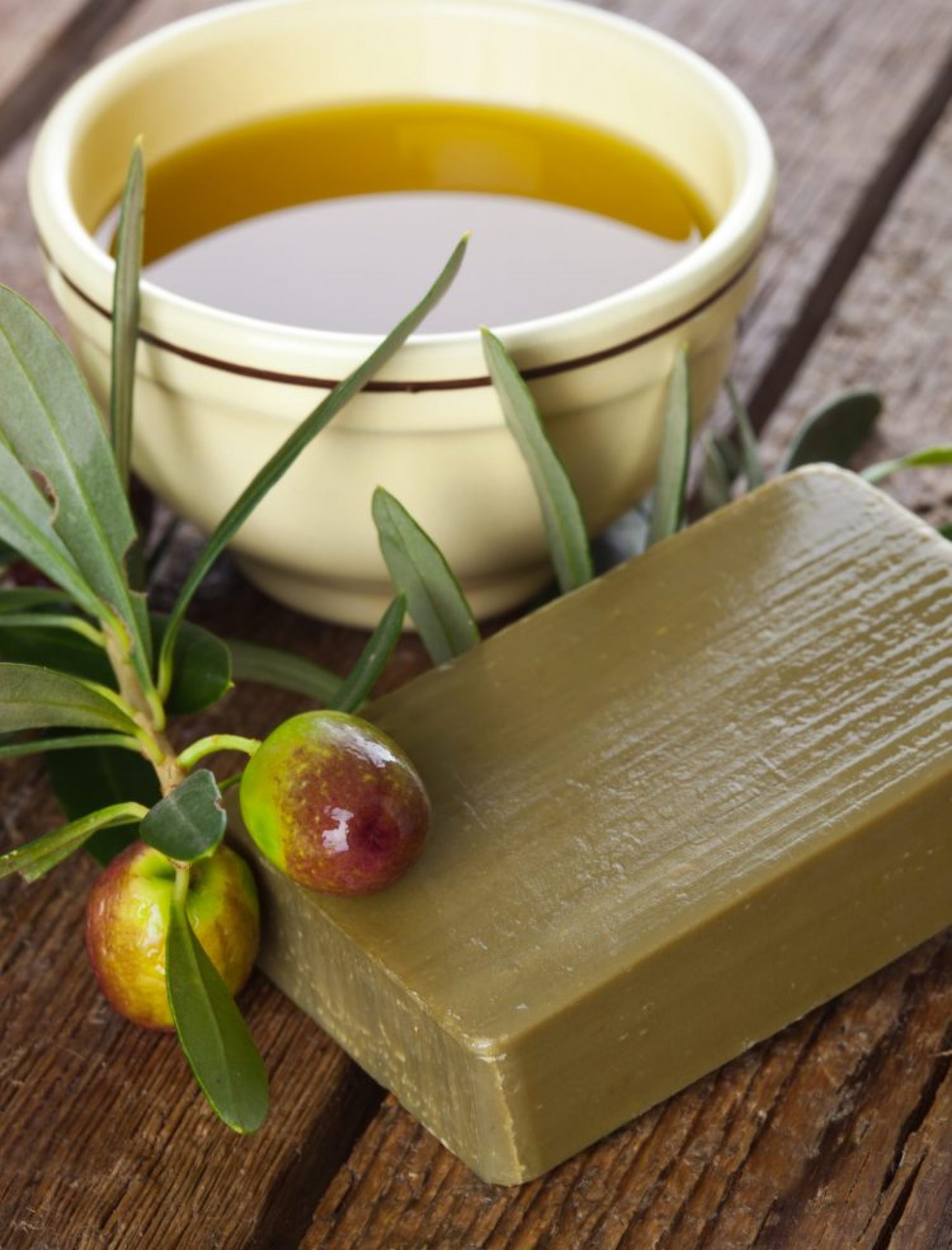 Aleppo soap and Olives on wooden table Aleppo soap and Olives